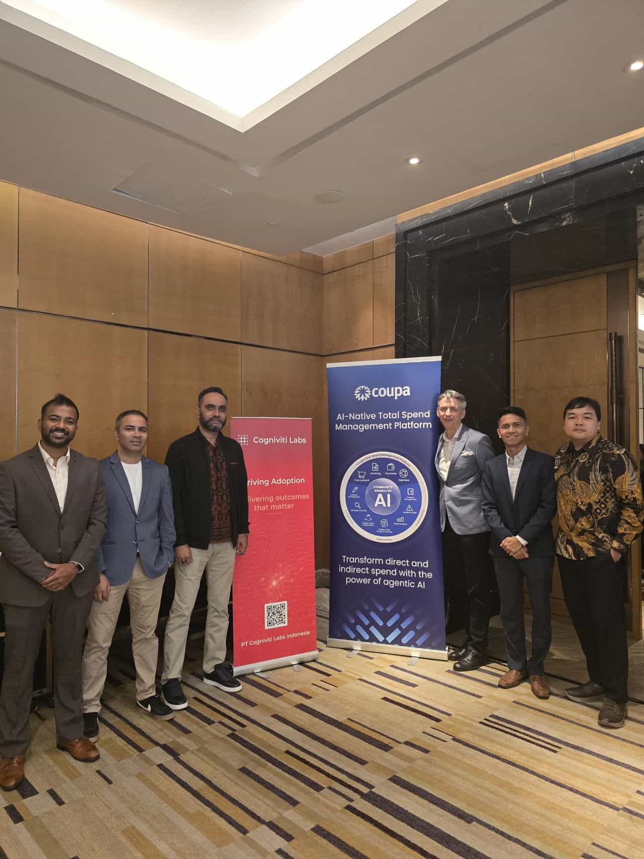 The PT Cogniviti Labs Indonesia team beside the Cogniviti Labs and Coupa banners at a Coupa event